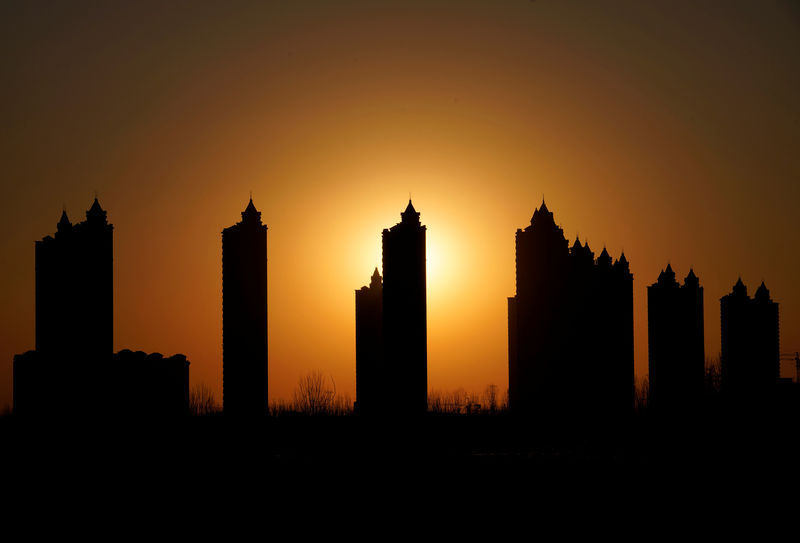 © Reuters. Apartments blocks are pictured during sunset on the outskirts of Tianjin