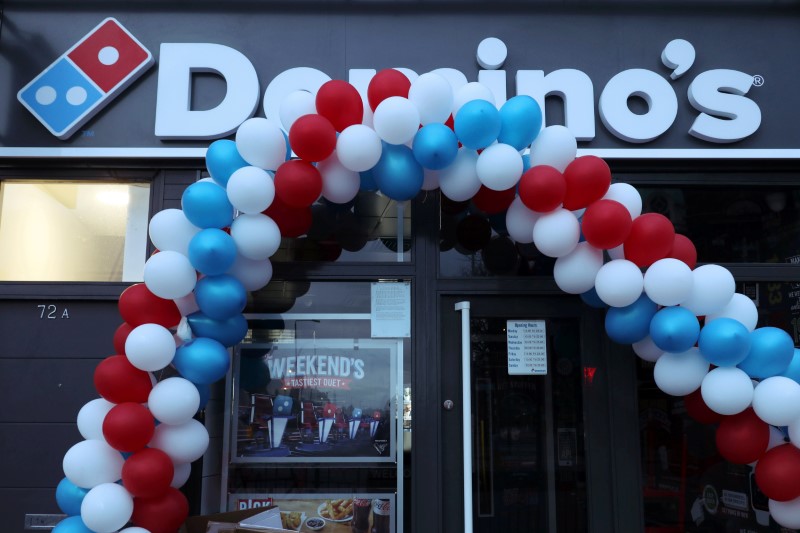© Reuters. FILE PHOTO: Balloons are seen on the front of a newly opened Domino's Pizza franchise in London, Britain