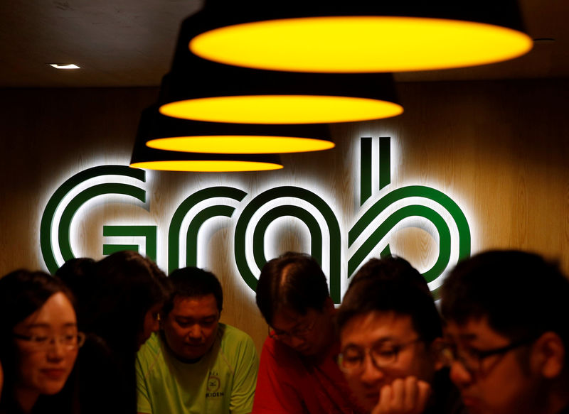 © Reuters. FILE PHOTO: New hires relax at a lounge area in a Grab office in Singapore