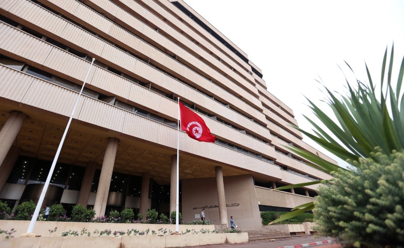 © Reuters. People walk out of the Central Bank in Tunis