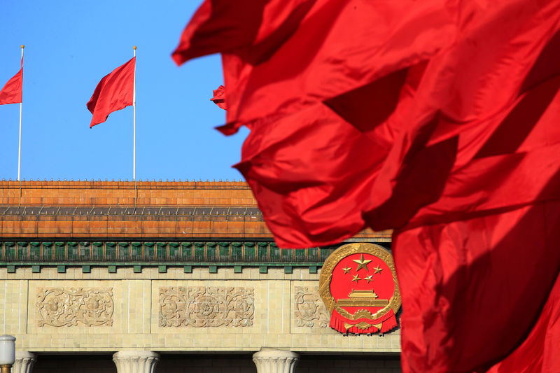 © Reuters. Red flags flutter outside the Great Hall of the People before the second plenary session of the CPPCC in Beijing