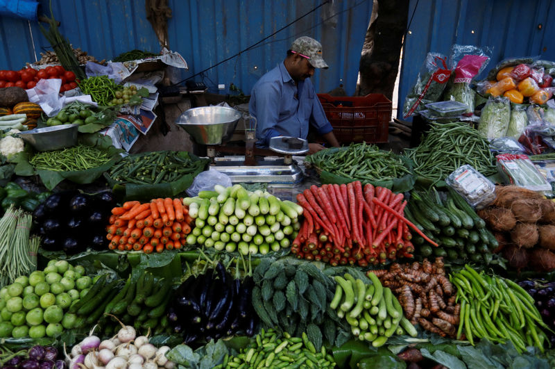 © Reuters. Vegetable vendor waits for customers at a market in Mumbai