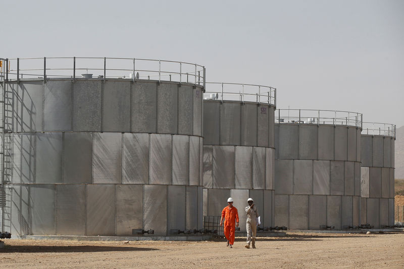 © Reuters. Рабочие у нефтехранилищ Tullow Oil в Локичаре, Кения