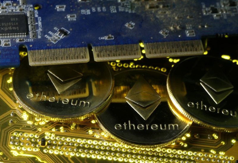 © Reuters. FILE PHOTO - Representations of the Ethereum virtual currency standing on the PC motherboard are seen in this illustration picture