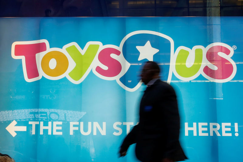 © Reuters. FILE PHOTO - A man passes by Toys R Us store at Times Square in New York