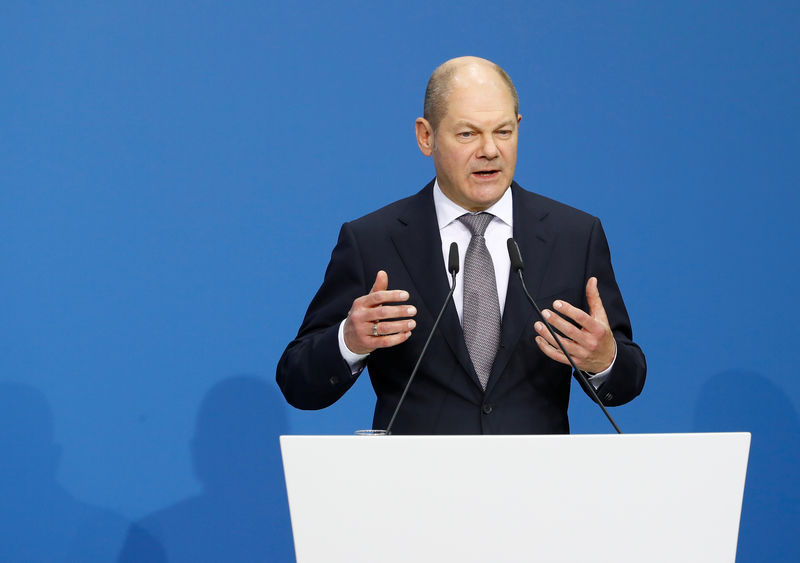© Reuters. Leader of the Social Democratic Party (SPD) Olaf Scholz speaks prior to signing a coalition deal during a ceremony in Berlin