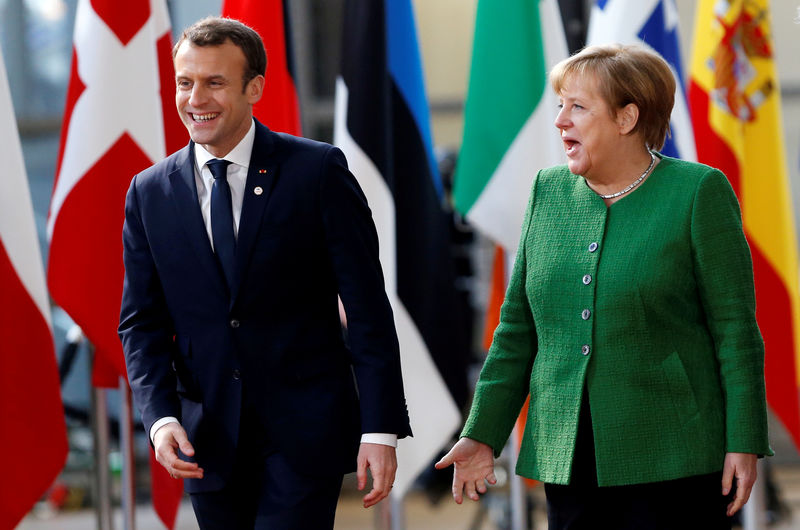 © Reuters. FILE PHOTO: French President Macron and Germany's Chancellor Merkel arrive at a EU heads of state informal meeting in Brussels