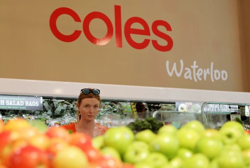 © Reuters. A woman walks in the fruit and vegetables section at a Coles supermarket (main Wesfarmers brand) in Sydney