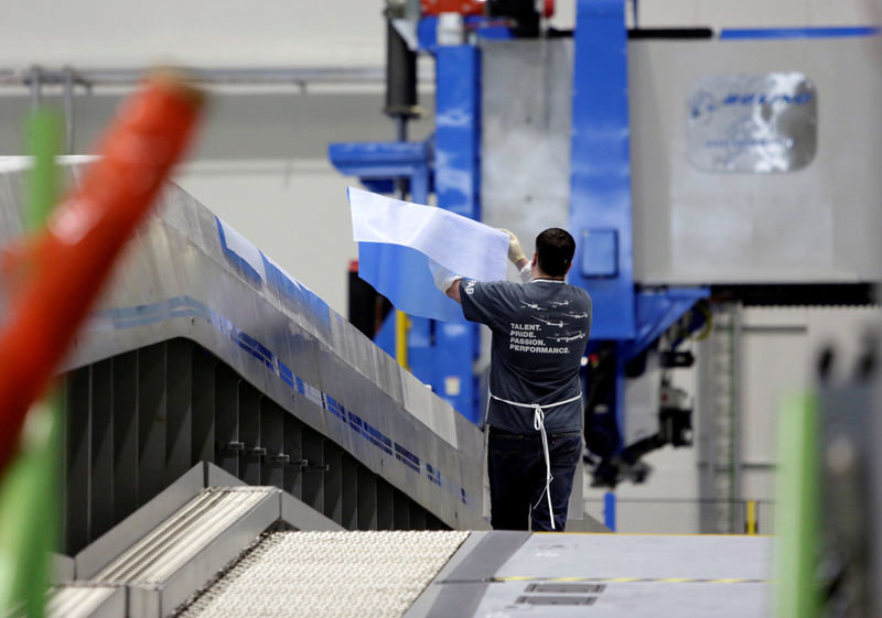 © Reuters. FILE PHOTO:    A Boeing employee moves materials on an automated fiber placement machine during a tour of the composite wing center at Boeing's production facility for the Boeing 777X in Everett, Washington