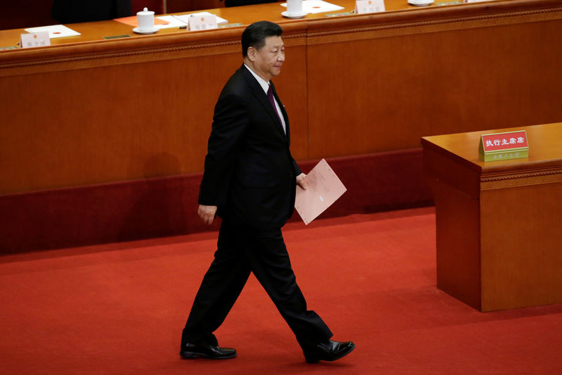 © Reuters. Chinese President Xi Jinping walks with his ballot before a vote at the fifth plenary session of the National People's Congress (NPC) at the Great Hall of the People in Beijing