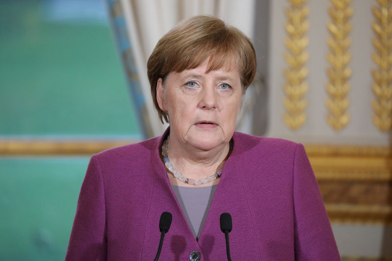 © Reuters. FILE PHOTO - German Chancellor Angela Merkel gives a joint press conference with France's President at the Eylsee presidential Palace in Paris