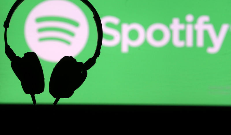 © Reuters. A headset is seen in front of a screen projection of Spotify logo, in this picture illustration