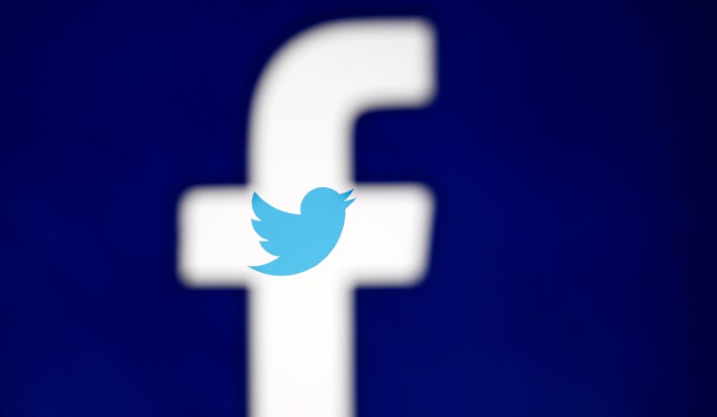 © Reuters. A 3D-printed Facebook logo is displayed in front of the Twitter logo, in this illustration