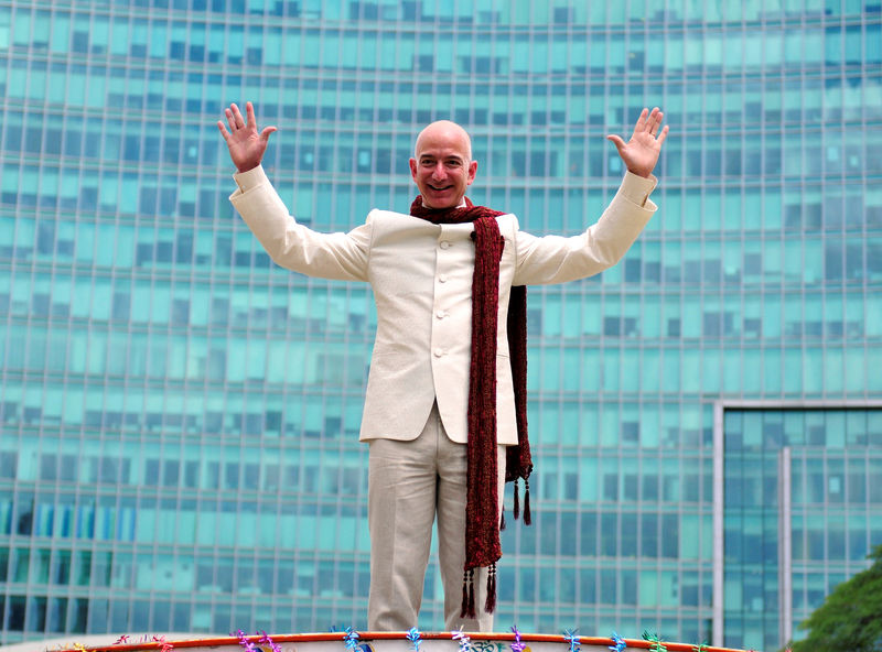 © Reuters. FILE PHOTO: Jeff Bezos, founder and CEO of Amazon, poses as he stands atop a supply truck during a photo opportunity at the premises of a shopping mall in Bangalore