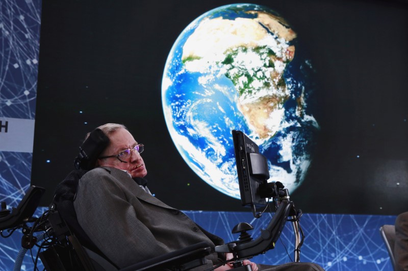 © Reuters. FILE PHOTO: Physicist Stephen Hawking sits on stage during an announcement of the Breakthrough Starshot initiative with investor Yuri Milner in New York