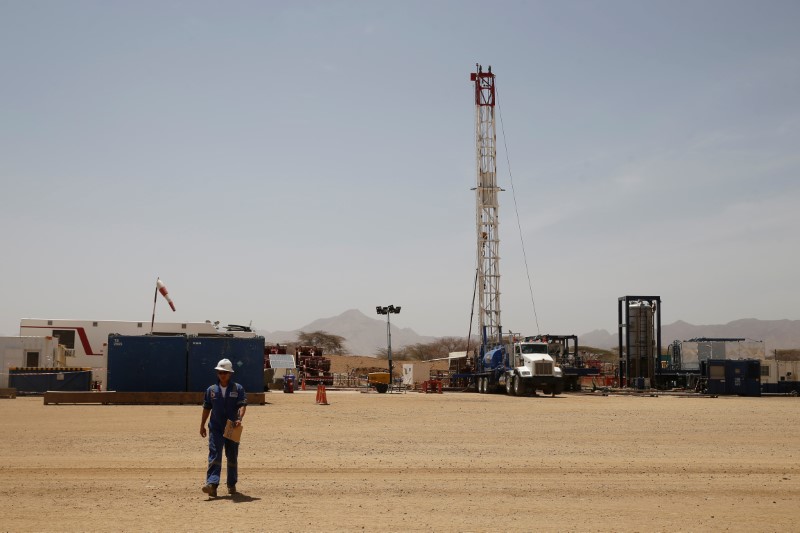 © Reuters. Worker walks at a Tullow Oil explorational drilling site in Lokichar