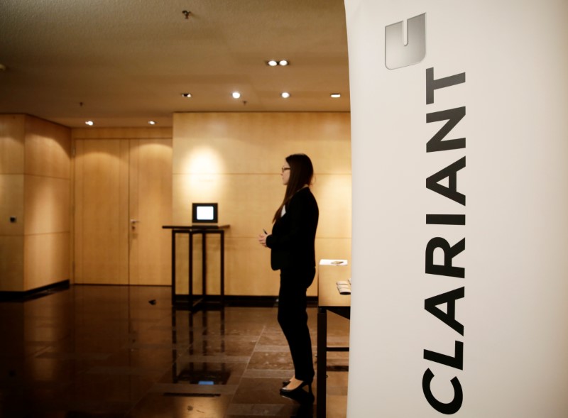 © Reuters. Woman stands next to logo of Swiss specialty chemicals company Clariant ahead of a news conference to present full-year results in Zurich