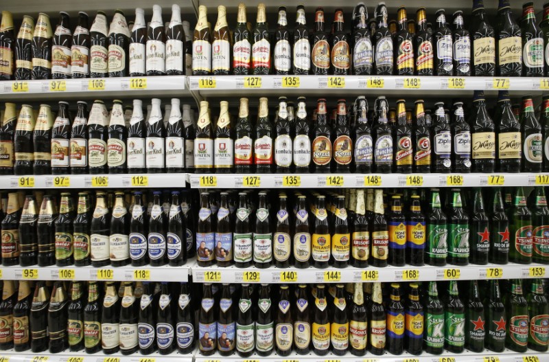 © Reuters. Bottles of beer are seen on display at a new outlet of French grocery retailer Auchan on the day of its opening in Moscow