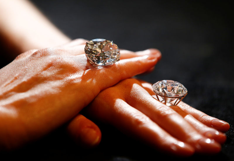 © Reuters. A model poses with two white diamonds, each over 50 carats, at Sotheby's auction house in London