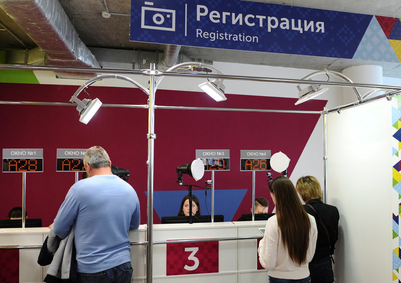 © Reuters. Employees serve customers at a 2018 FIFA World Cup FAN ID distribution centre in Rostov-on-Don