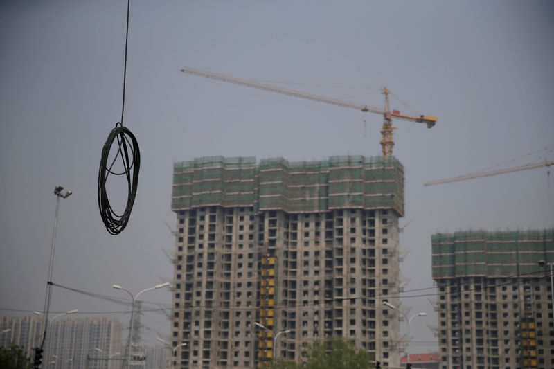 © Reuters. FILE PHOTO: A cable is seen near residential buildings under construction in Beijing