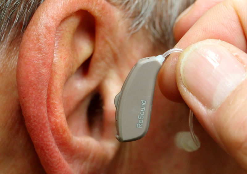 © Reuters. FILE PHOTO: Employee of GN, the world's fourth largest maker of hearing aids, demonstrates the use of ReSound LiNX in Vienna