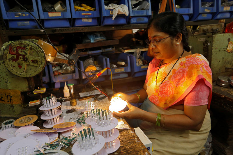 © Reuters. Woman tests LEDs after installing them onto a grid in Mumbai