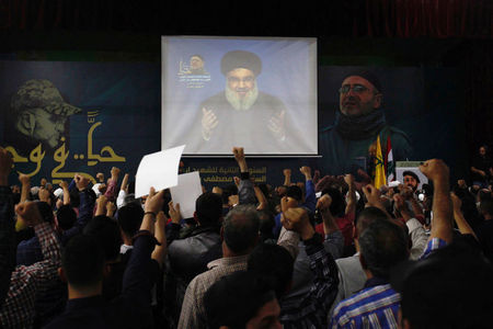 © Reuters. Lebanon's Hezbollah leader Sayyed Hassan Nasrallah is seen on a video screen as he addresses his supporters in Beirut