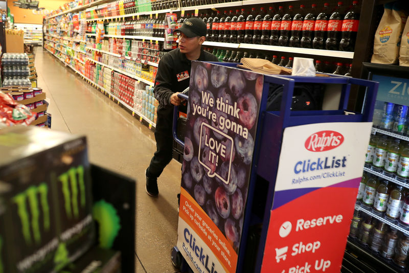 © Reuters. FILE PHOTO: A Ralph's grocery store employee loads a cart for a customer who has used Kroger's ClickList online ordering and curbside pickup service in Los Angeles