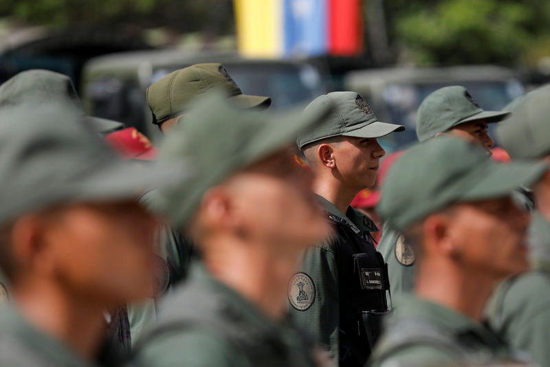 © Reuters. Soldiers stand in formation before the start of a ceremony to kick off the distribution of security forcers and voting materials to be used in the upcoming presidential elections, at Fort Tiuna military base in Caracas