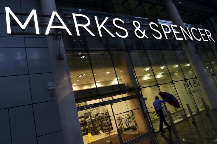 © Reuters. FILE PHOTO: File photo of a man leaving a Marks & Spencer store in London