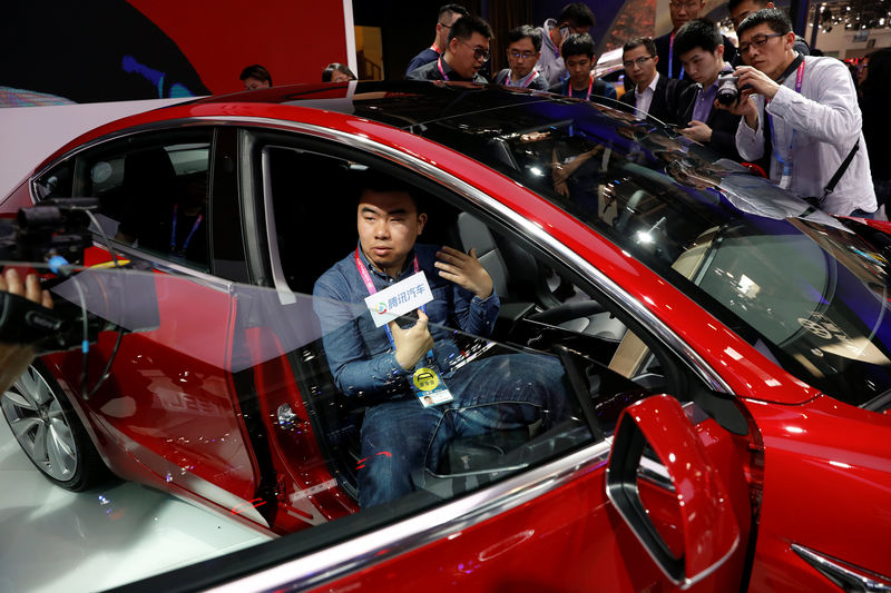 © Reuters. The Tesla Model 3 is displayed during a media preview of the Auto China 2018 motor show in Beijing
