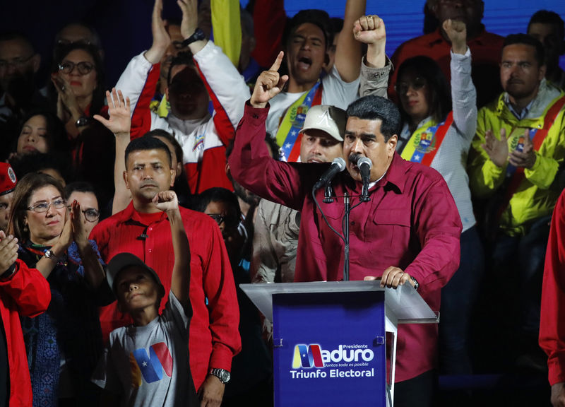 © Reuters. Venezuela's President Maduro stands with supporters after the results of the election were released in Caracas