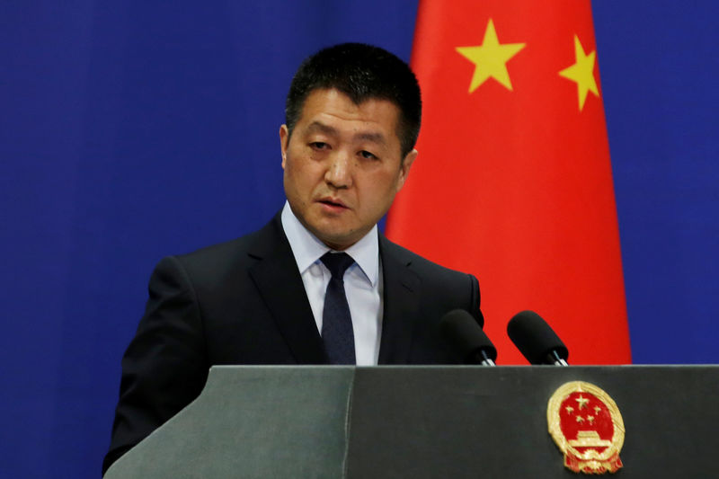 © Reuters. FILE PHOTO: Chinese Foreign Ministry spokesman Lu Kang answers questions about a major bus accident in North Korea, during a news conference in Beijing