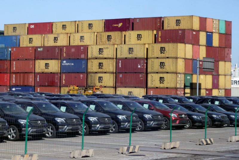 © Reuters. Imported Mercedes Benz cars are seen next to containers at Tianjin Port