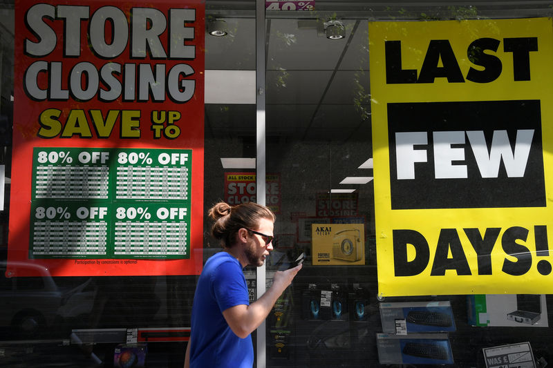 © Reuters. Closing down signs hang in the window of a Maplin electrical store in central London