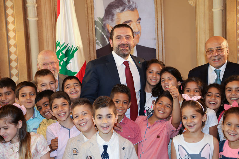 © Reuters. Lebanon's outgoing Prime Minister Saad al-Hariri meets Islamic orphans in Beirut