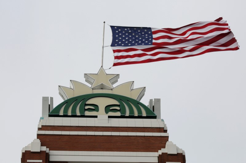 © Reuters. A flag flies above the company's headquarters as Starbucks Corp opens the first upscale Starbucks Reserve store at the Starbucks headquarters in Seattle