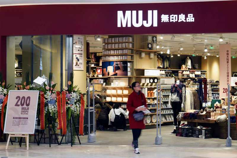 © Reuters. Woman walks outside a newly opened Muji store at a shopping mall in Hangzhou