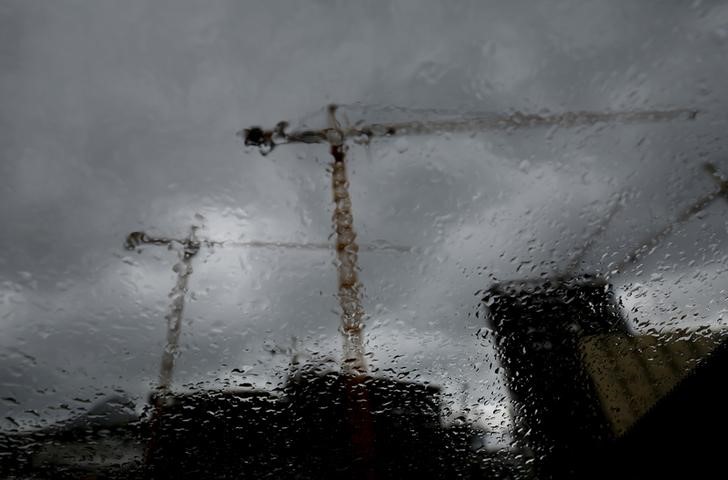 © Reuters. A construction project is seen though a rain covered window in Cape Town