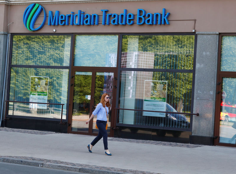 © Reuters. A woman walks past Meridian Trade Bank in Riga