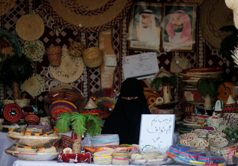 © Reuters. A Saudi woman sits in her shop at heritage village during Gulf Coastal Cultural Festival at Dammam Corniche, Dammam