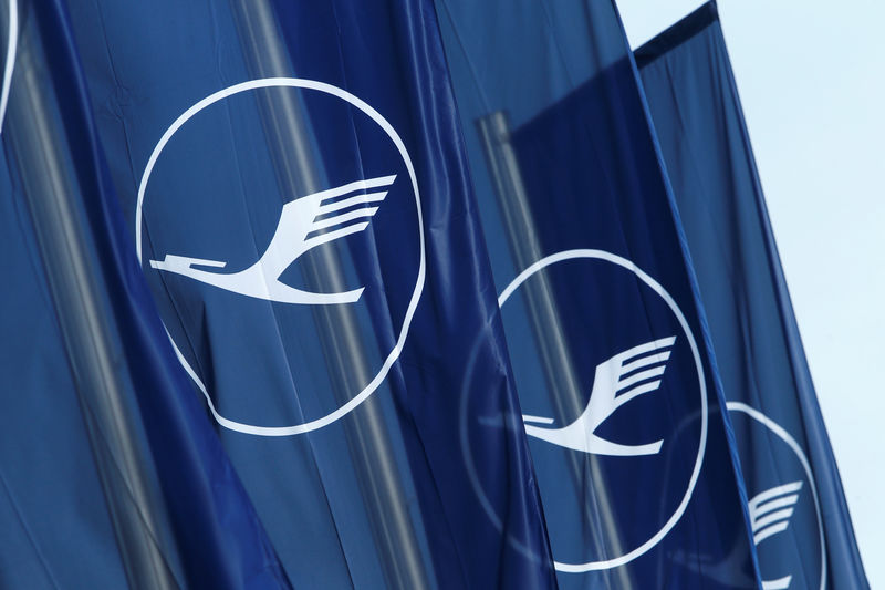 © Reuters. FILE PHOTO: Flags with the German airline Lufthansa sign flutter next to the office building in Frankfurt
