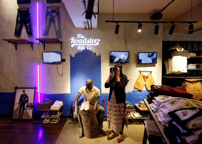 © Reuters. A customer poses with a virtual reality headset as she browses through a catalouge of products inside a Roadster store in Bengaluru
