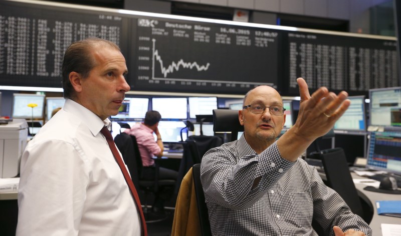 © Reuters. Traders talk in front of DAX board at the stock exchange in Frankfurt