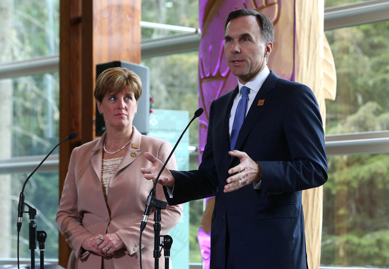 © Reuters. Canada's Minister of Finance Bill Morneau and Minister of International Development Marie-Claude Bibeau speak to media during the G7 Finance Ministers Summit in Whistler