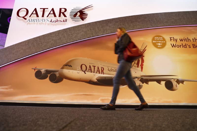 © Reuters. Visitor passes by the Qatar Airways booth at the International Tourism Trade Fair ITB in Berlin