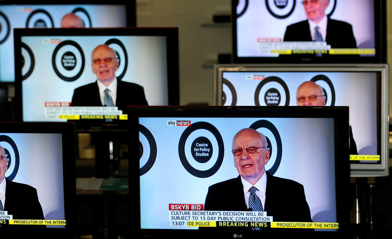 © Reuters. FILE PHOTO: The Chairman, and CEO of News Corporation, Murdoch, is seen talking on Sky News on television screens in an electrical store in Edinburgh