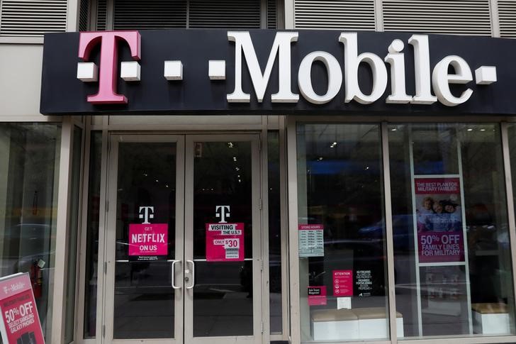 © Reuters. FILE PHOTO - A sign for a T-Mobile store is seen in Manhattan, New York