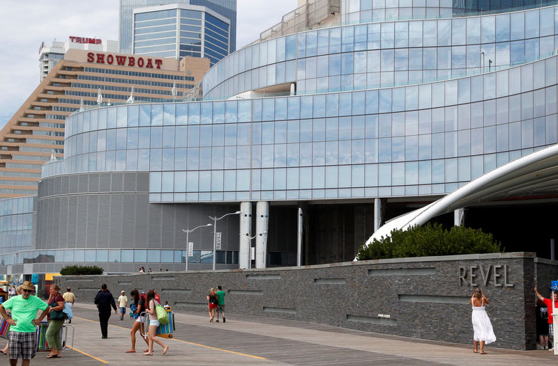 © Reuters. FILE PHOTO: People walk outside the Revel Casino Hotel in Atlantic City